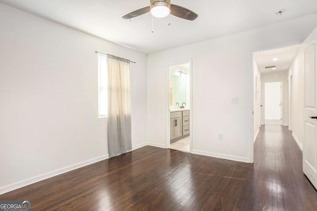 spare room featuring ceiling fan and dark wood-type flooring