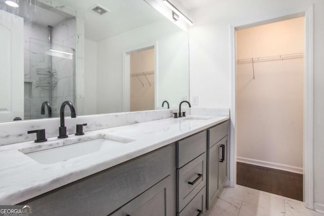 bathroom with vanity and walk in shower