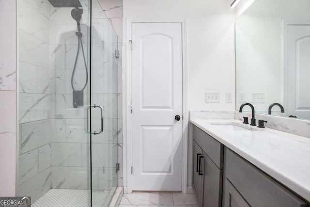 bathroom with vanity and a shower with door