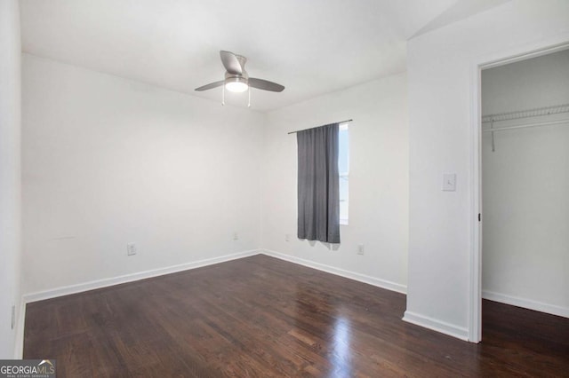 unfurnished bedroom featuring ceiling fan, dark hardwood / wood-style flooring, and a closet