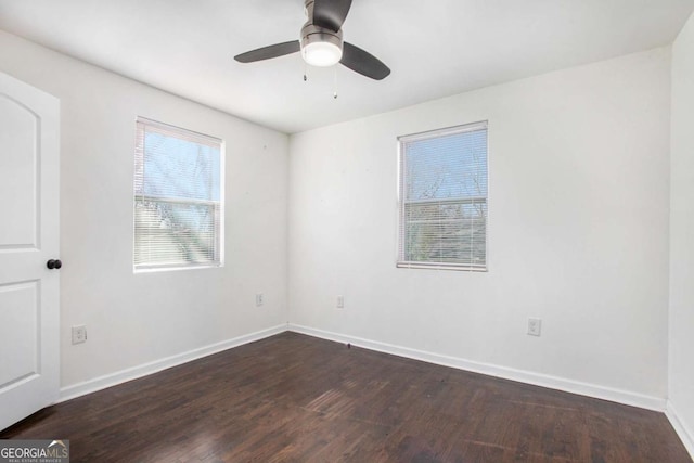 unfurnished room with ceiling fan and dark wood-type flooring