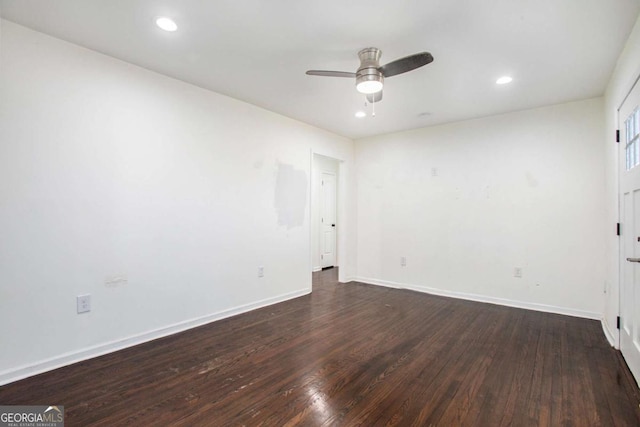 unfurnished room with ceiling fan and dark wood-type flooring