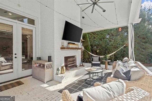 view of patio / terrace featuring an outdoor living space with a fireplace and french doors