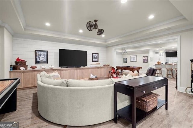 living room with light hardwood / wood-style flooring, a raised ceiling, and pool table