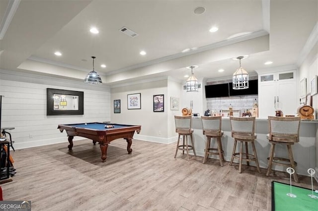 playroom with light wood-type flooring, ornamental molding, pool table, and a tray ceiling