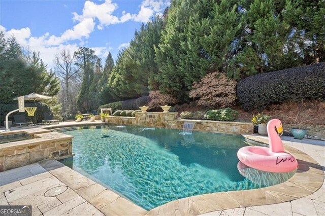 view of pool with a patio area and an in ground hot tub