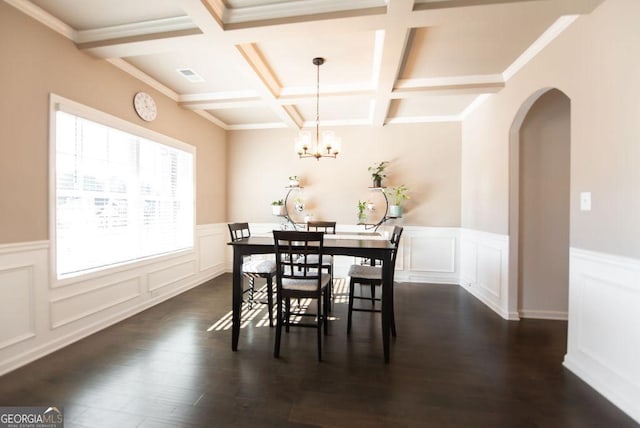 dining room featuring coffered ceiling, beamed ceiling, dark hardwood / wood-style floors, crown molding, and a chandelier