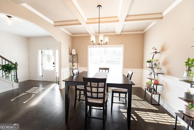 dining space featuring coffered ceiling, crown molding, a notable chandelier, beam ceiling, and dark hardwood / wood-style flooring