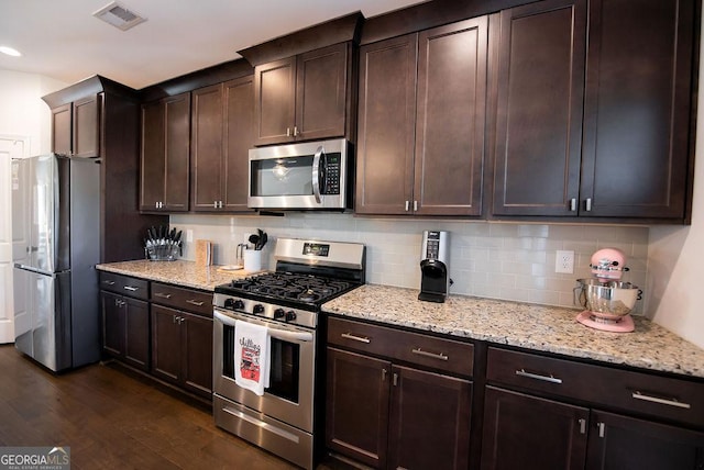 kitchen featuring decorative backsplash, dark hardwood / wood-style flooring, stainless steel appliances, and dark brown cabinetry