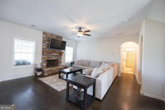 living room with a fireplace, dark hardwood / wood-style floors, and ceiling fan