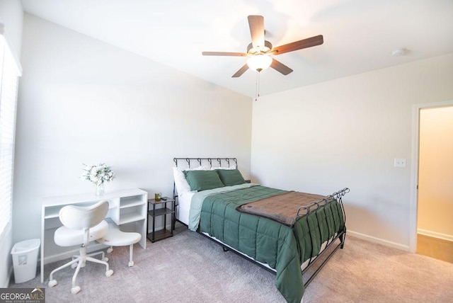 bedroom with ceiling fan and light colored carpet