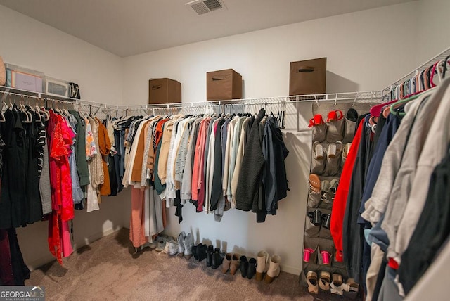 walk in closet with carpet floors