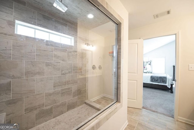 bathroom featuring tile patterned floors and tiled shower