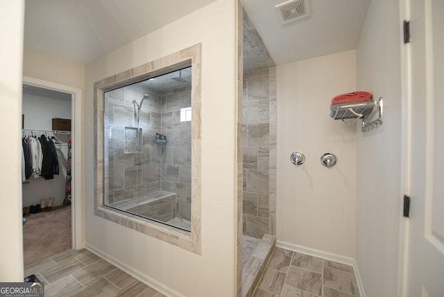 bathroom with tiled shower