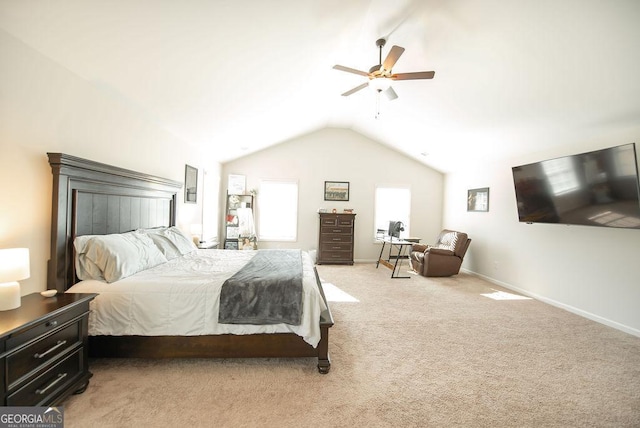 bedroom with ceiling fan, light colored carpet, and vaulted ceiling