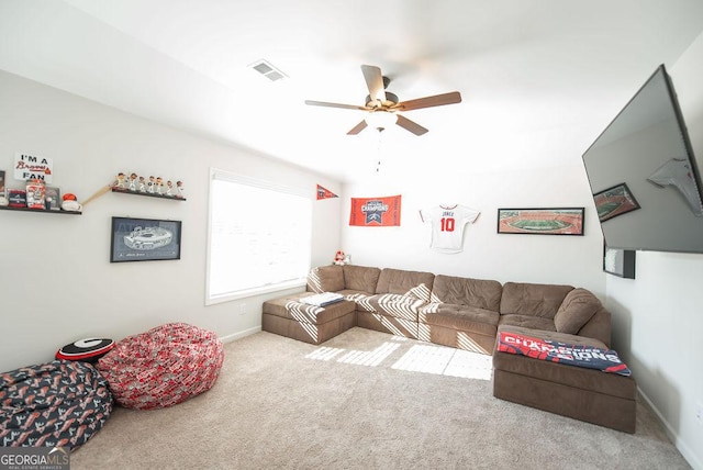 carpeted living room with ceiling fan