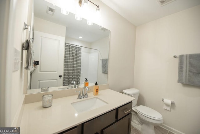 bathroom featuring a shower with curtain, vanity, toilet, and tile patterned floors