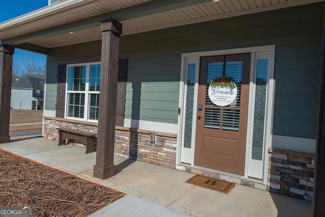 view of exterior entry featuring a porch