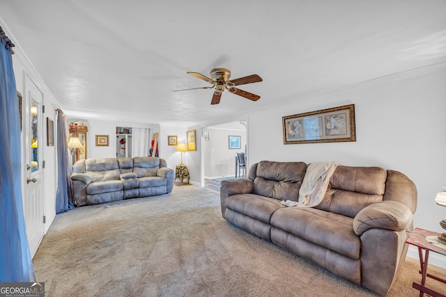 living room with carpet, ceiling fan, and ornamental molding