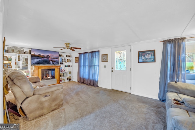 living room featuring carpet flooring, a wealth of natural light, and ceiling fan