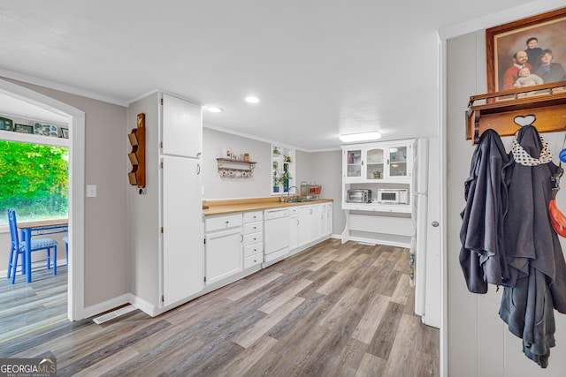 kitchen with white cabinetry, sink, light hardwood / wood-style flooring, crown molding, and white appliances