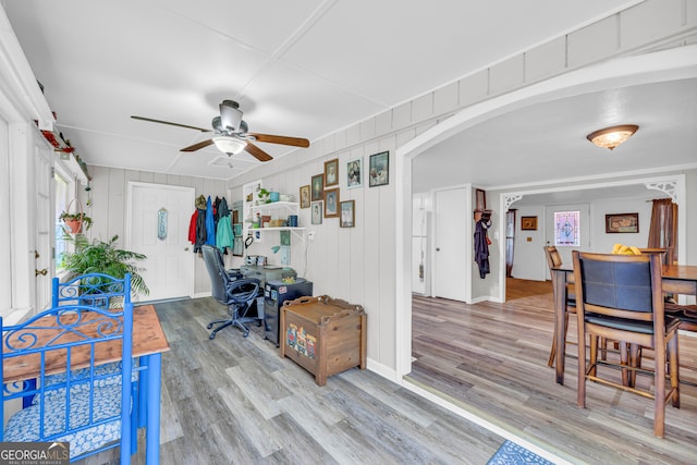 office space with wood-type flooring, ceiling fan, and a healthy amount of sunlight