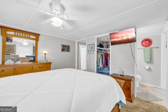 bedroom featuring ensuite bath, ceiling fan, a closet, and light carpet