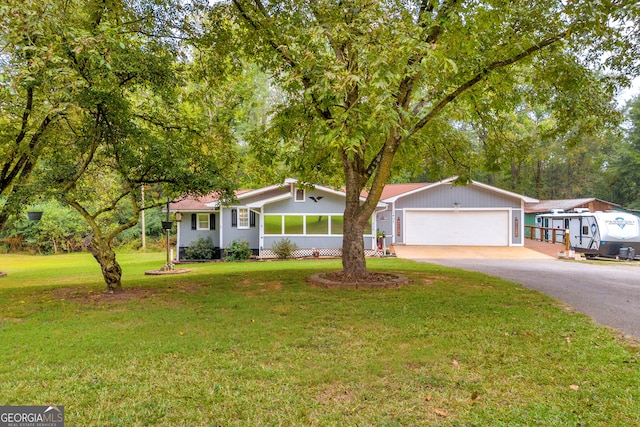 ranch-style house featuring a front yard and a garage