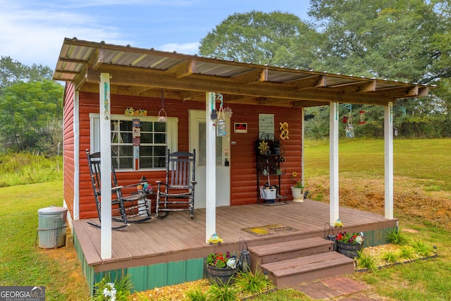 wooden deck featuring a yard