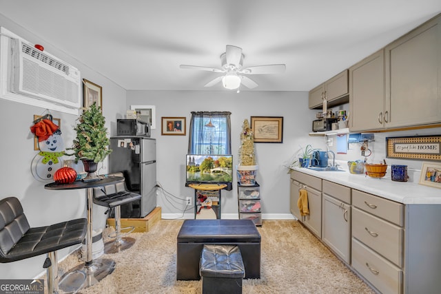 kitchen featuring light carpet, stainless steel fridge, gray cabinetry, ceiling fan, and sink