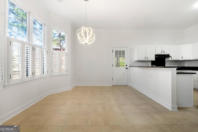 kitchen featuring white cabinets, light tile patterned floors, decorative light fixtures, and ornamental molding