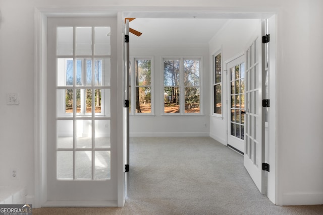 unfurnished sunroom featuring plenty of natural light and ceiling fan