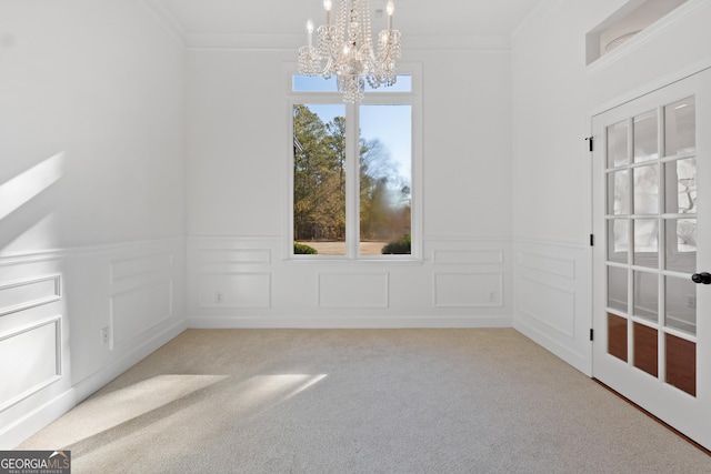 interior space with a notable chandelier, ornamental molding, and light carpet