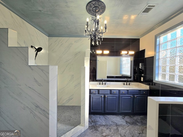 bathroom with a notable chandelier, vanity, ornamental molding, and tile walls