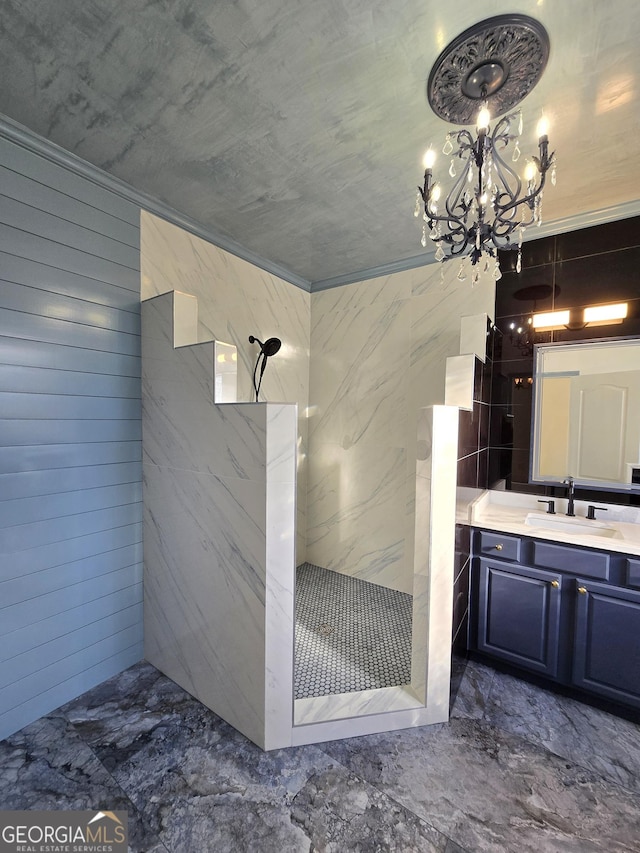 bathroom featuring a tile shower, vanity, ornamental molding, and a notable chandelier