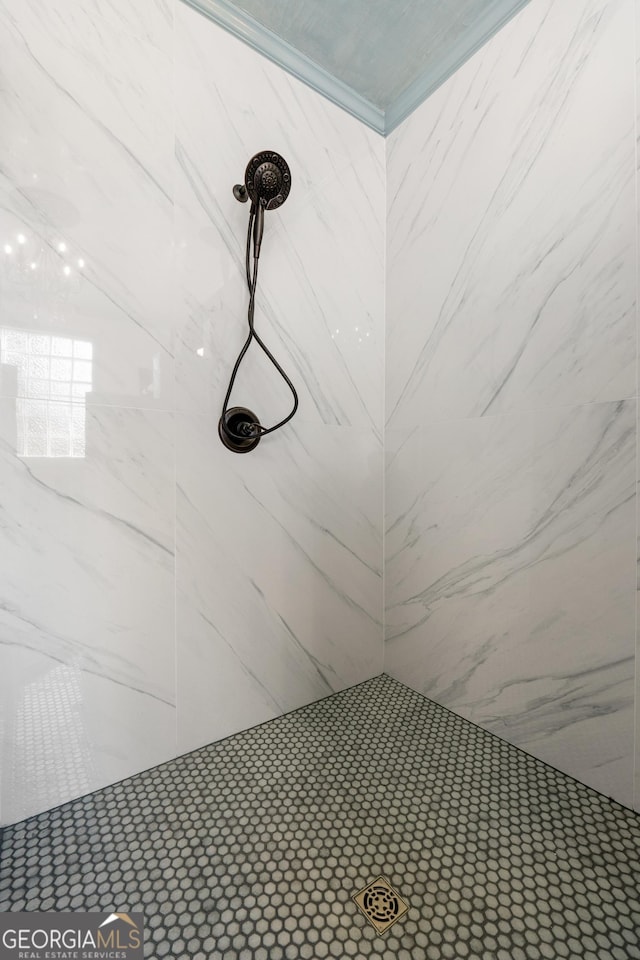 interior details featuring tiled shower