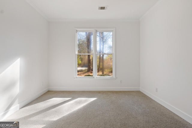 carpeted empty room featuring ornamental molding