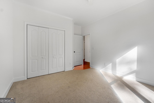 unfurnished bedroom featuring a closet, carpet floors, and ornamental molding