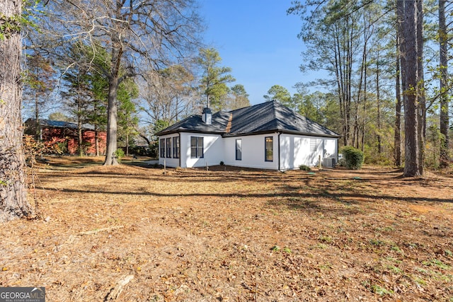 back of house featuring central AC