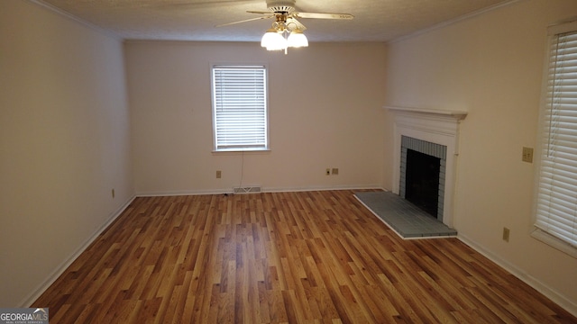 unfurnished living room featuring ceiling fan, a fireplace, a textured ceiling, and hardwood / wood-style flooring