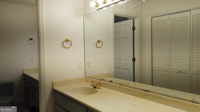 bathroom featuring vanity and toilet