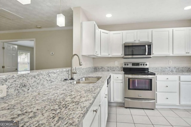 kitchen featuring ornamental molding, stainless steel appliances, sink, decorative light fixtures, and white cabinets