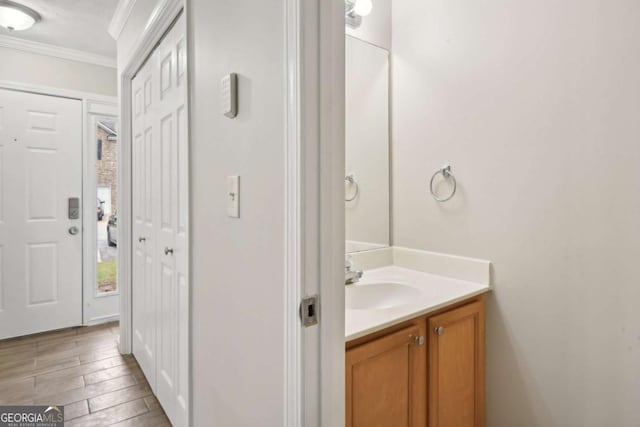 bathroom featuring vanity and ornamental molding