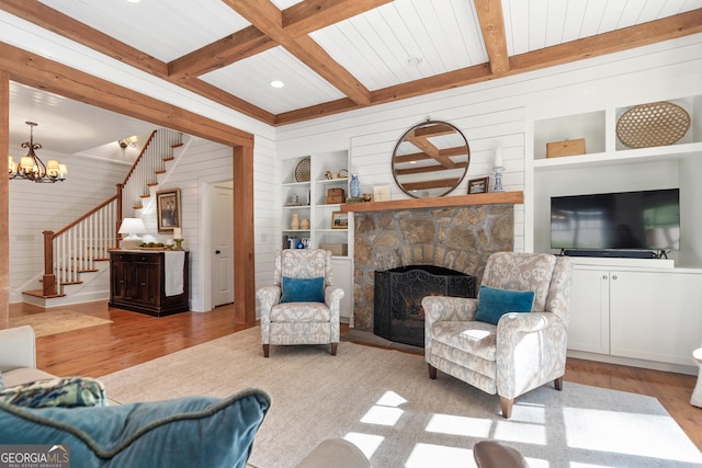 living room with beamed ceiling, stairway, built in features, and wood finished floors