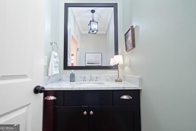 bathroom with crown molding and vanity