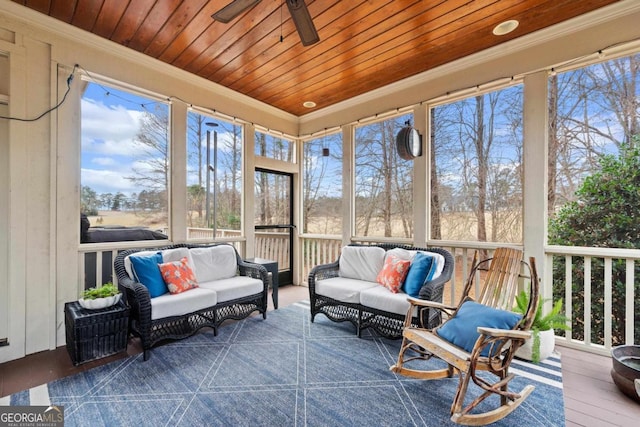 sunroom / solarium featuring a wealth of natural light, ceiling fan, and an outdoor hangout area