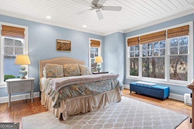 bedroom featuring wood-type flooring, crown molding, ceiling fan, and wooden ceiling