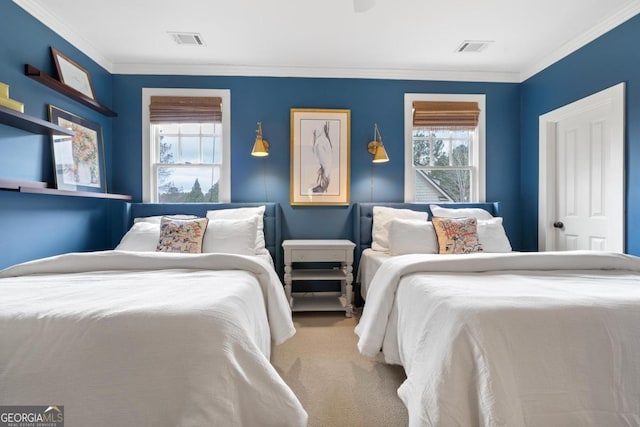carpeted bedroom with visible vents and crown molding