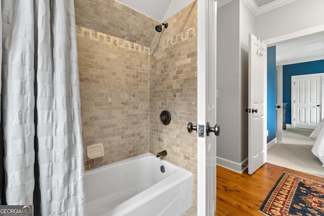 bathroom with shower / bathtub combination with curtain, wood-type flooring, and crown molding