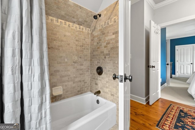 bathroom featuring baseboards, crown molding, shower / tub combo with curtain, and wood finished floors